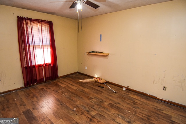 unfurnished room with a textured ceiling, ceiling fan, and dark wood-type flooring