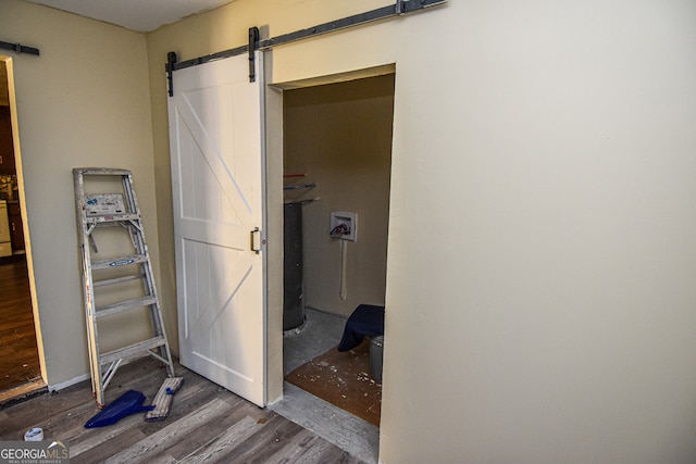 interior space with a barn door and dark wood-type flooring