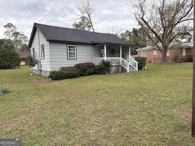 single story home featuring a front yard and covered porch