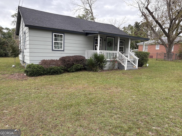 single story home featuring a porch and a front yard