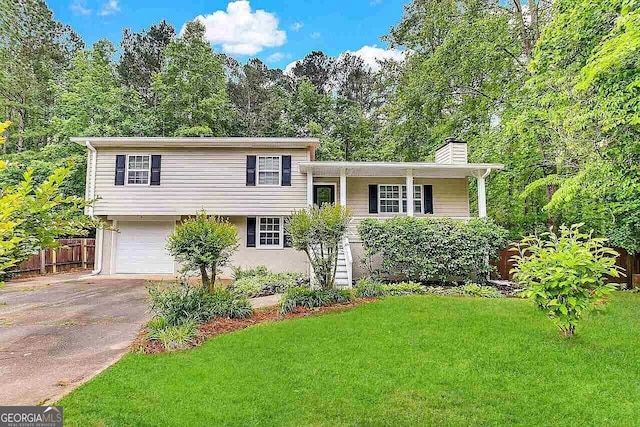 split level home featuring a garage and a front yard