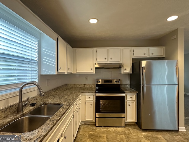 kitchen featuring white cabinetry, sink, light stone counters, and appliances with stainless steel finishes