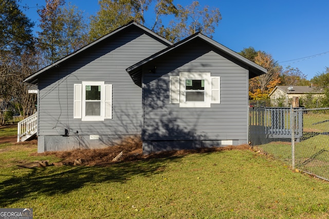 view of side of home featuring a yard