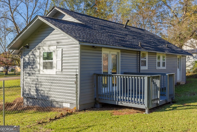 back of house with a yard and a deck