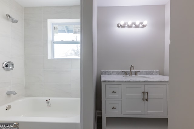 bathroom with vanity and tiled shower / bath combo