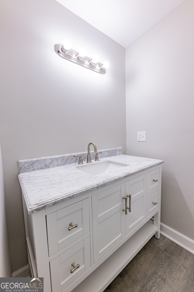 bathroom featuring vanity and wood-type flooring