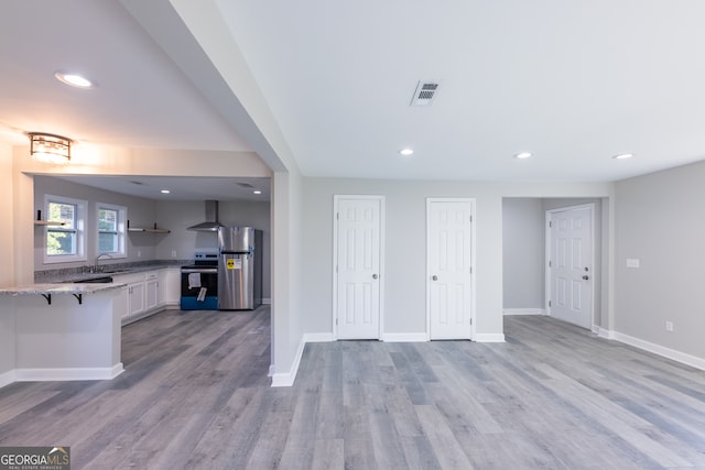 unfurnished living room with light wood-type flooring and sink