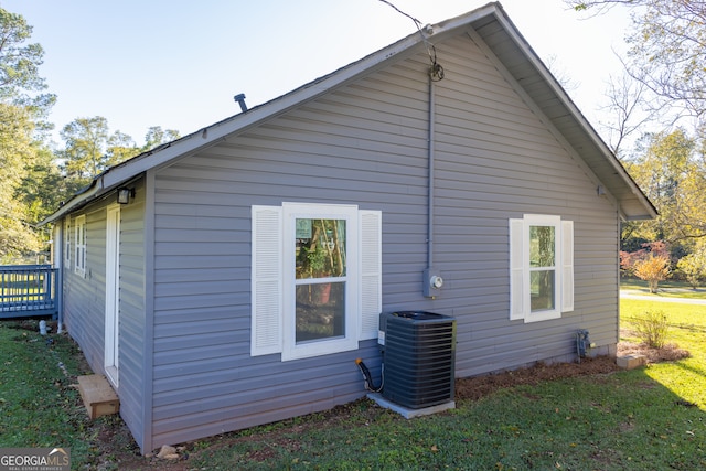 view of home's exterior with a yard and cooling unit