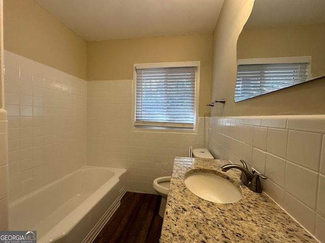 bathroom with vanity, toilet, wood-type flooring, and tile walls