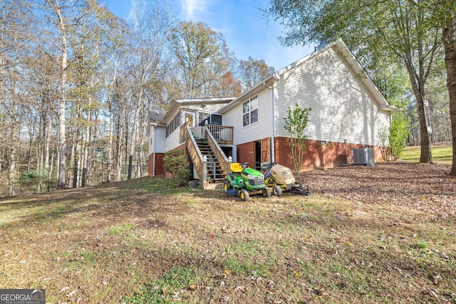 back of house with stairway, a wooden deck, cooling unit, and a yard