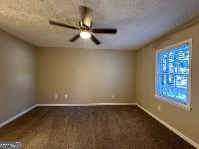 carpeted empty room with ceiling fan and a textured ceiling