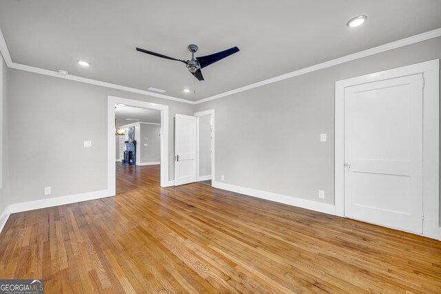 spare room featuring ceiling fan, light hardwood / wood-style floors, and ornamental molding