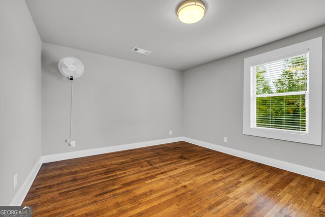 spare room with hardwood / wood-style floors