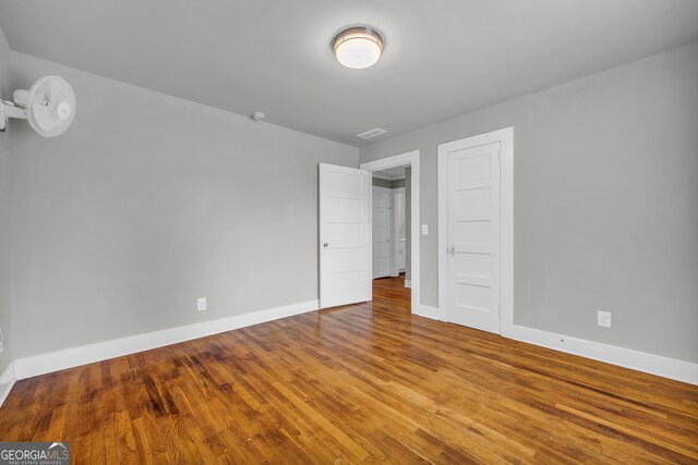 unfurnished bedroom featuring hardwood / wood-style flooring