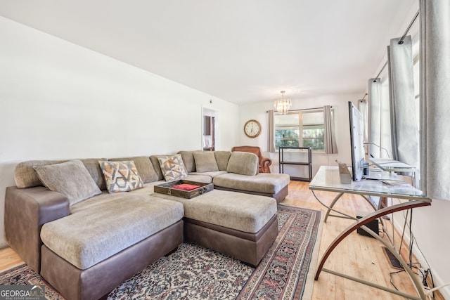 living room featuring light hardwood / wood-style floors and an inviting chandelier