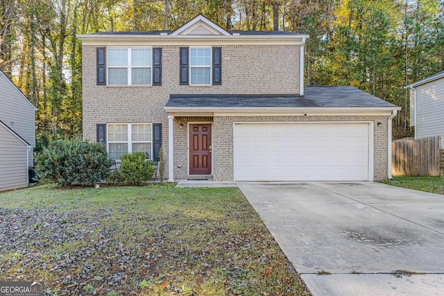 view of front property featuring a garage and a front lawn