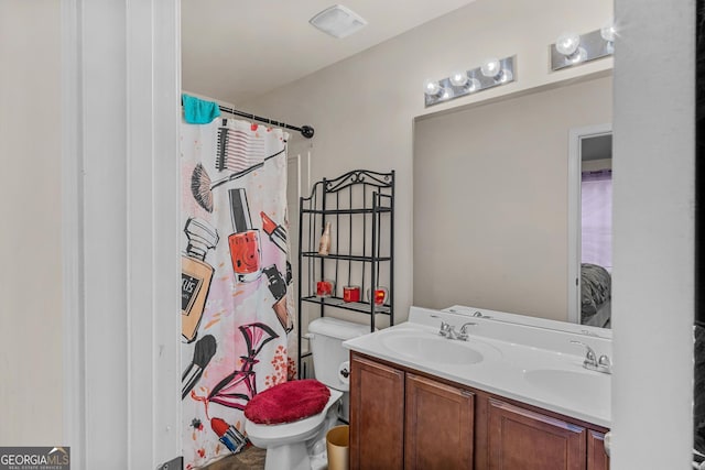 bathroom with vanity, toilet, and curtained shower