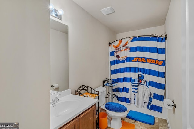 bathroom with toilet, vanity, and a shower with shower curtain