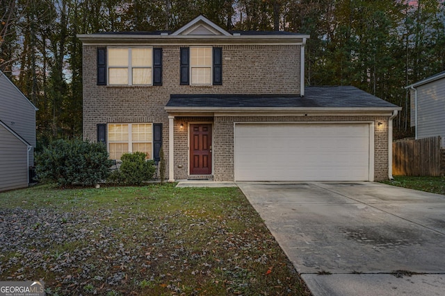 front facade featuring a garage and a front lawn