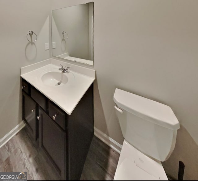 bathroom featuring hardwood / wood-style floors, vanity, and toilet