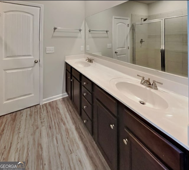 bathroom featuring vanity, a shower with shower door, and hardwood / wood-style flooring