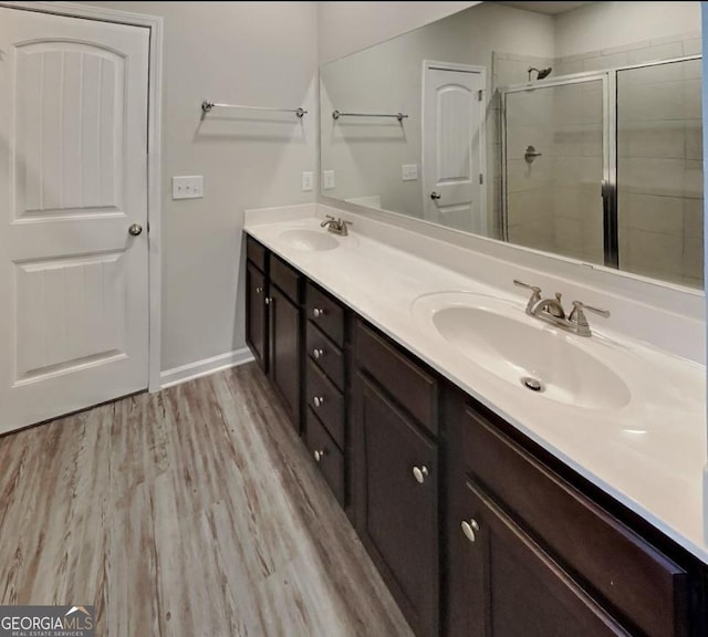 2108 Irvin Ct, Kennesaw, GA 30144 - bathroom with double vanity, a stall shower, and wood finished floors