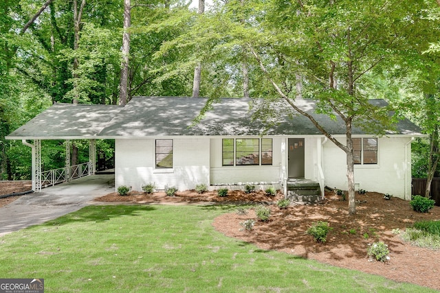 single story home with a front yard and a carport