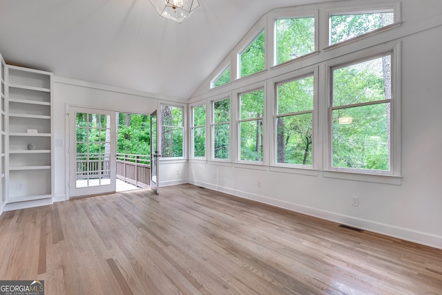 unfurnished sunroom with a wealth of natural light and vaulted ceiling