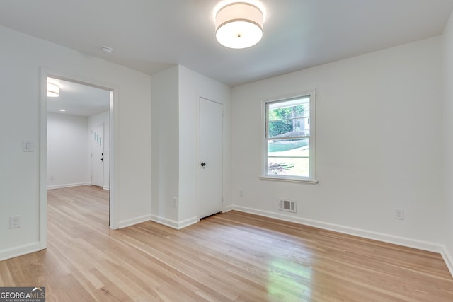 spare room with light hardwood / wood-style flooring