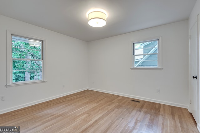 empty room featuring plenty of natural light and light wood-type flooring