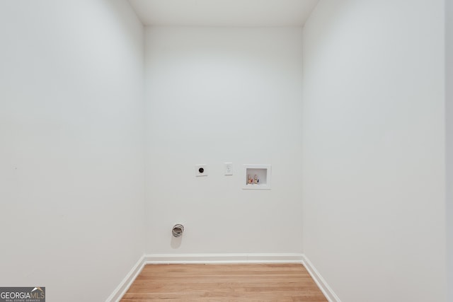 clothes washing area with electric dryer hookup, light hardwood / wood-style floors, and hookup for a washing machine