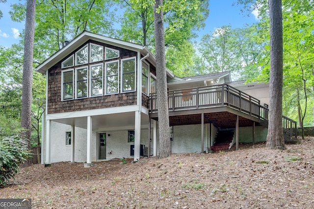 back of house featuring central AC unit and a deck