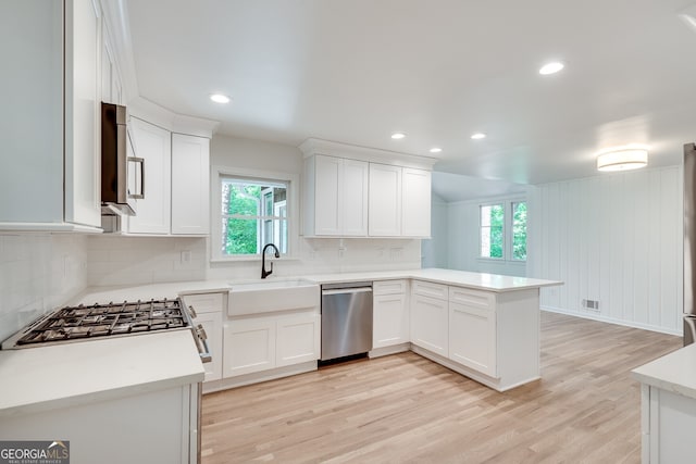 kitchen featuring a healthy amount of sunlight, white cabinetry, and stainless steel appliances