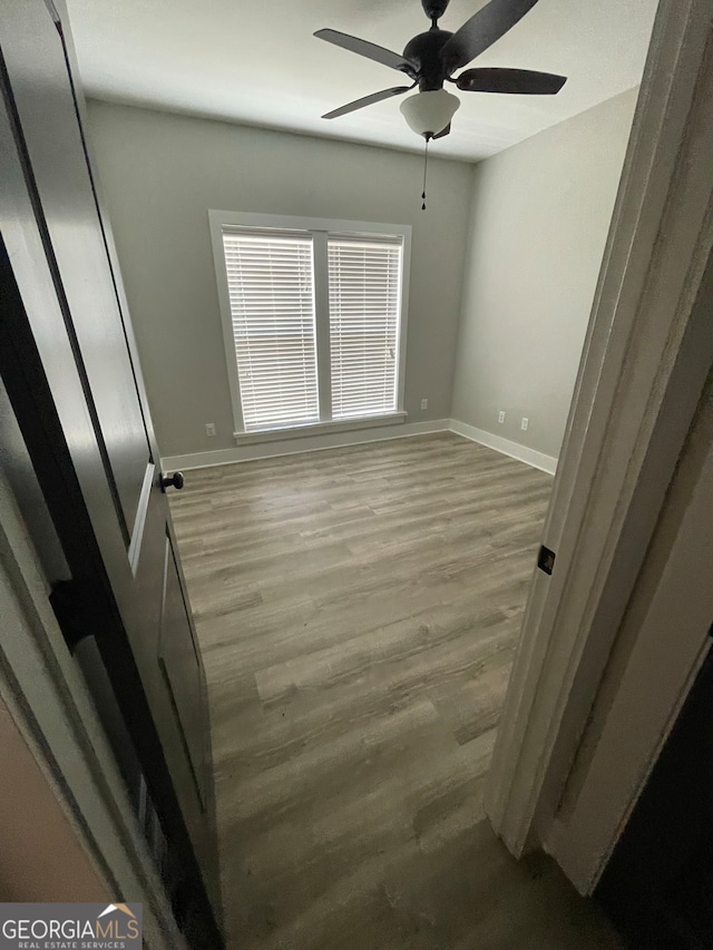 spare room with ceiling fan and light hardwood / wood-style flooring