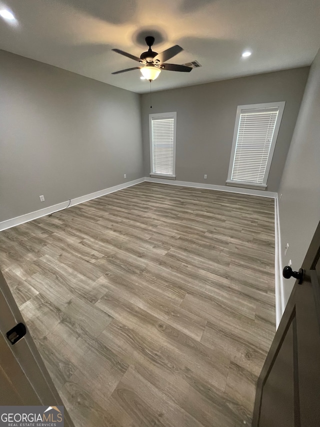 unfurnished room featuring ceiling fan and light hardwood / wood-style flooring