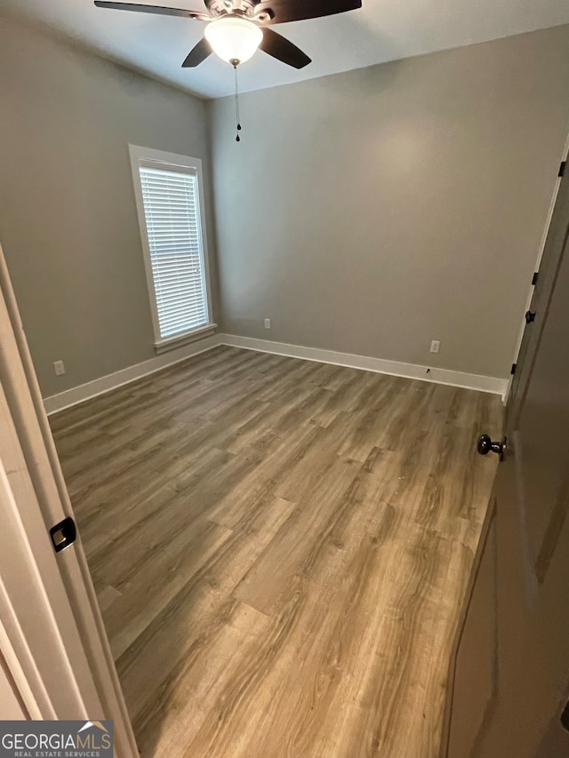 unfurnished room featuring hardwood / wood-style floors and ceiling fan