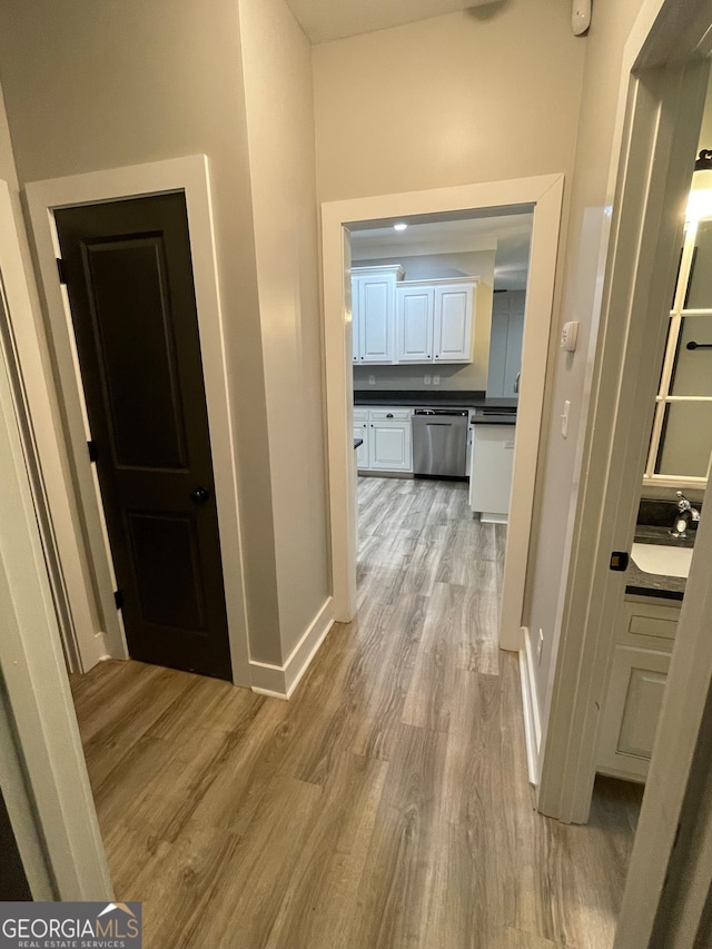 hallway with light hardwood / wood-style flooring