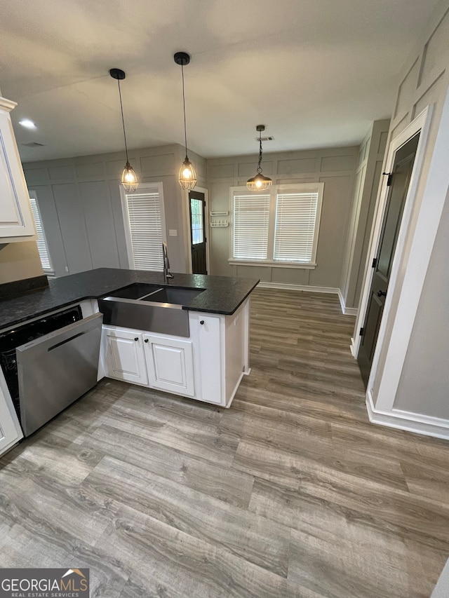 kitchen featuring dishwasher, kitchen peninsula, decorative light fixtures, white cabinets, and light wood-type flooring