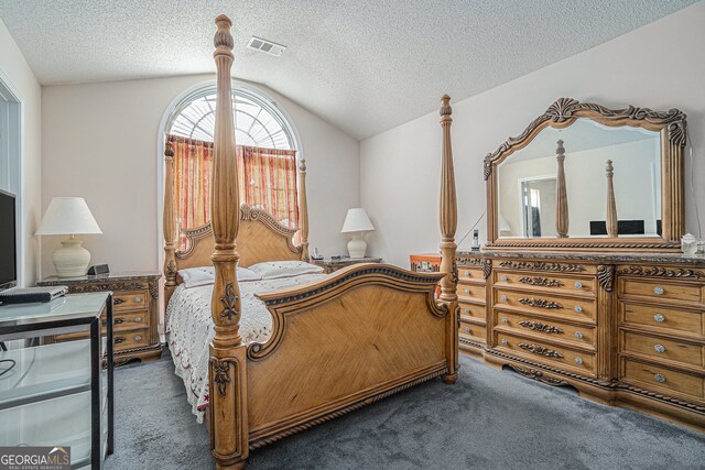 carpeted bedroom with a textured ceiling and vaulted ceiling