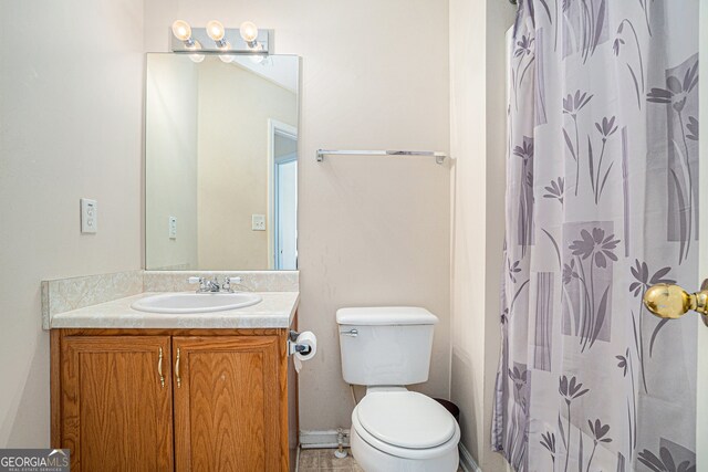 bathroom with vanity, toilet, and walk in shower