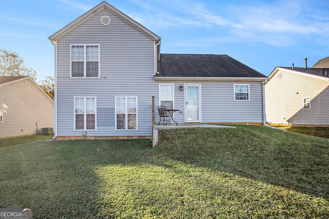 back of property featuring a patio area, a yard, and central AC