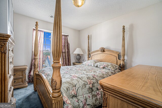 carpeted bedroom with a textured ceiling