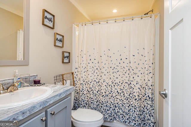 bathroom featuring vanity, toilet, and walk in shower