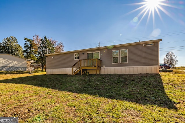 rear view of property featuring a lawn