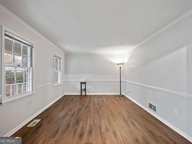 spare room featuring dark hardwood / wood-style floors and ornamental molding