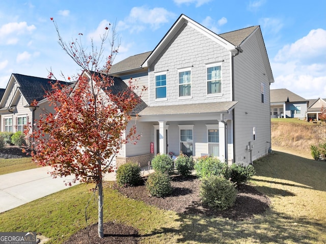 view of front of home with a porch and a front lawn