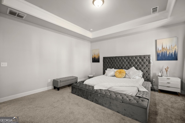 bedroom with crown molding, carpet flooring, and a raised ceiling