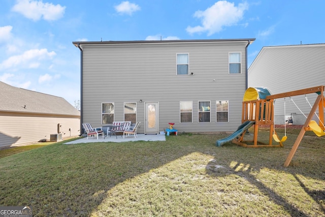 rear view of house featuring a playground, a patio, a yard, and central AC unit