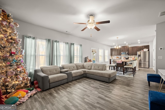 living room featuring ceiling fan and light wood-type flooring