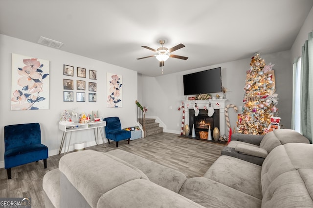 living room with hardwood / wood-style floors and ceiling fan